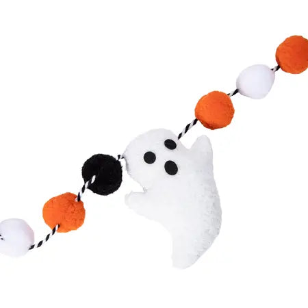 Halloween ghost garland featuring a plush white ghost with black eyes and nose, strung with orange, black, and white pom-poms on a black-and-white twisted cord, shown on a plain white background. Sold at LFG Energy Club