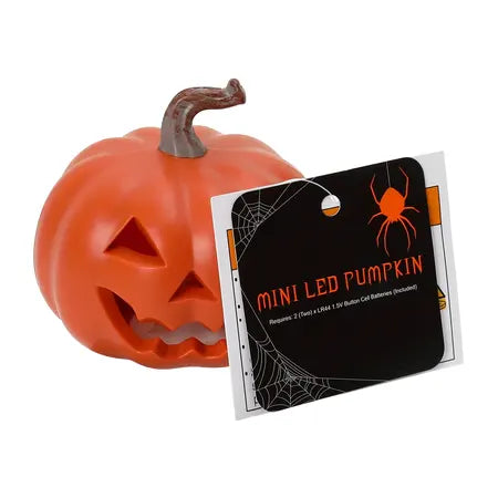 Mini orange LED Halloween pumpkin shown with its product tag, requiring two LR44 button cell batteries that are included, available at LFG Energy Club.