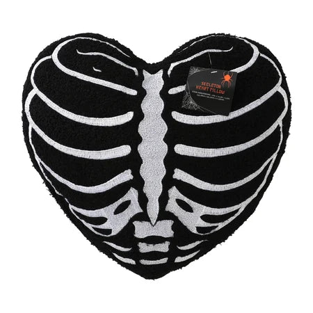 Front view of the black skeleton rib cage heart pillow with its product tag attached near the top sold by LFG Energy Club.