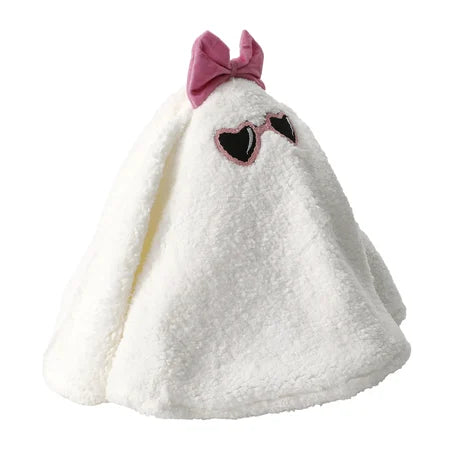 Side-angle view of the white Halloween ghost pillow wearing a pink bow and heart-shaped sunglasses sold by LFG Energy Club.
