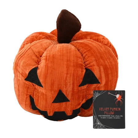 Front view of the orange Halloween velvet pumpkin pillow with a black jack-o’-lantern face, brown stem and product tag sold by LFG Energy Club.